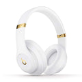 White and gold beats headphones